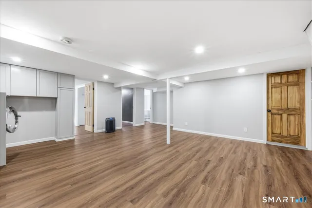a view of an empty room with wooden floor