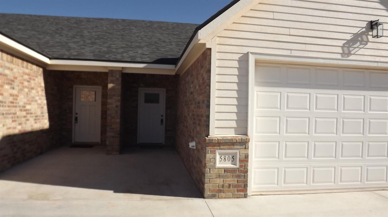 5805 Virginia Avenue Lubbock, TX 79407 - Photo 3 of 9 a view of a brick house with a large window