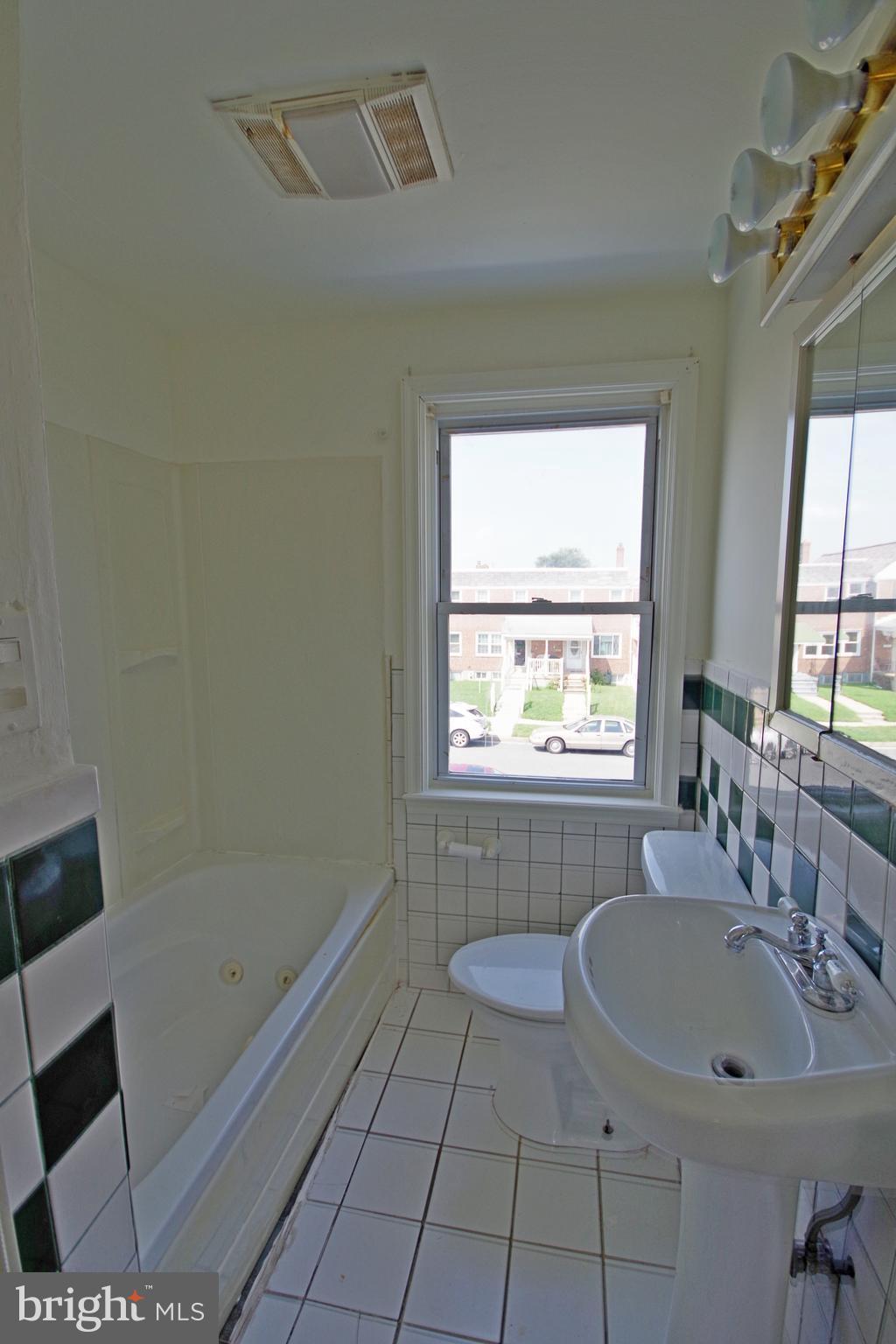 7457 Lawrence Road Dundalk, MD 21222 - Photo 12 of 24 a bathroom with a sink a toilet and a bathtub