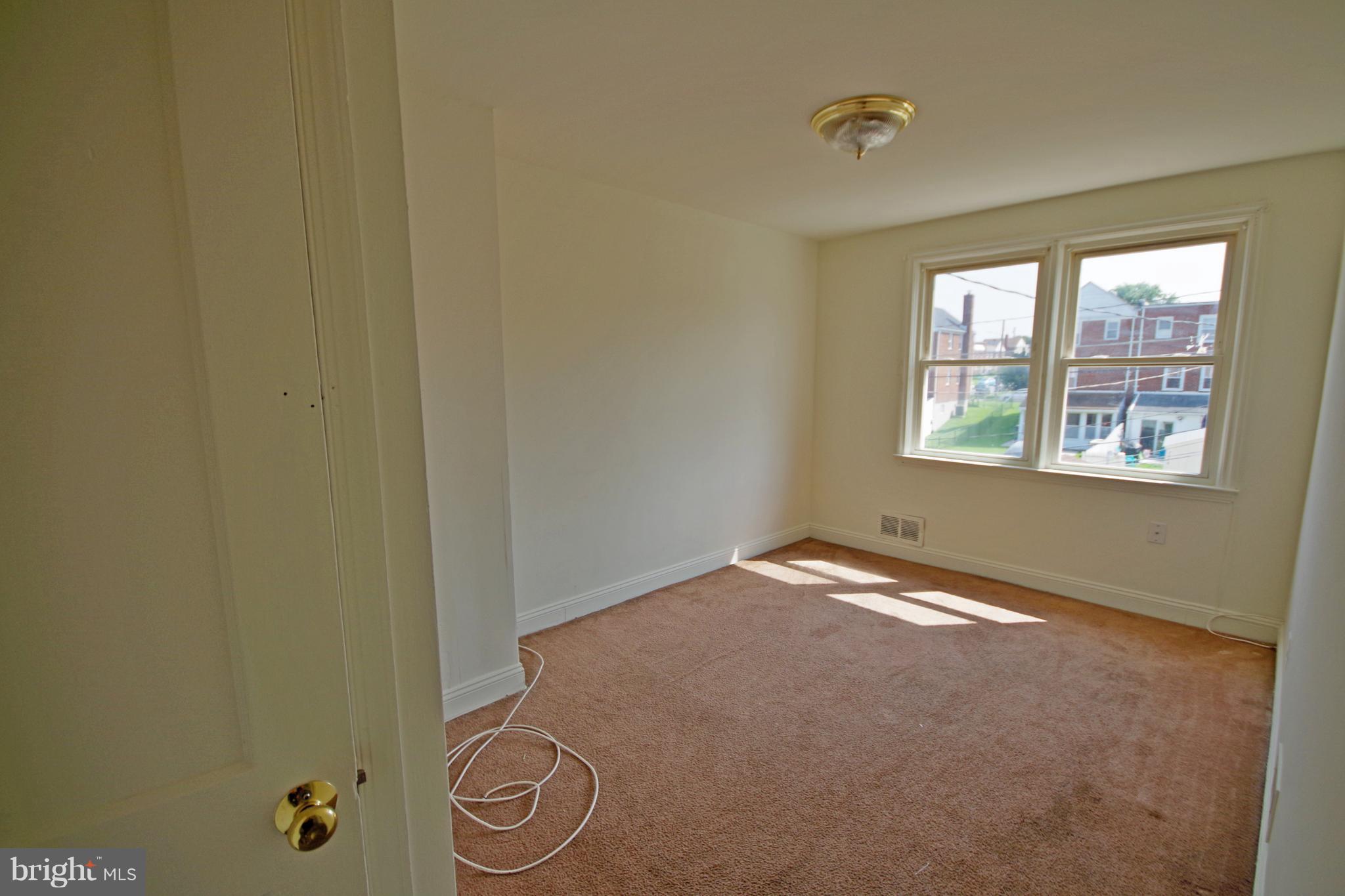7457 Lawrence Road Dundalk, MD 21222 - Photo 13 of 24 a view of empty room with windows