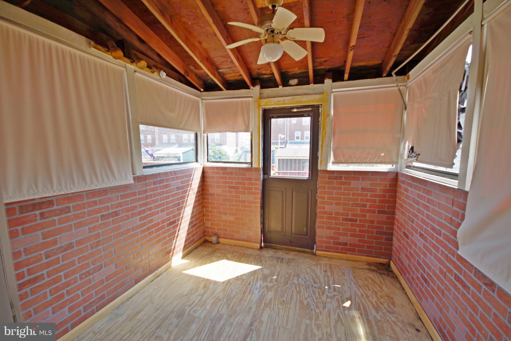 7457 Lawrence Road Dundalk, MD 21222 - Photo 17 of 24 a view of an empty room with wooden floor and a window
