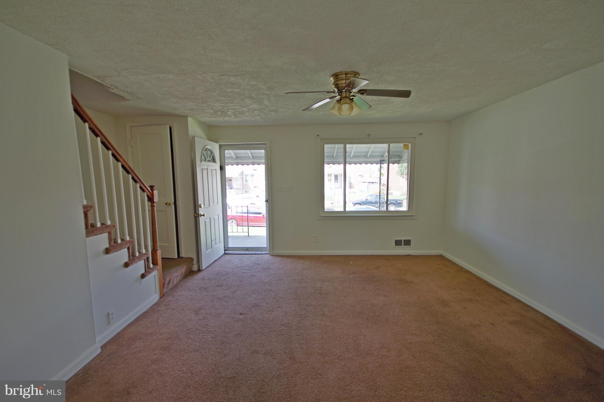 7457 Lawrence Road Dundalk, MD 21222 - Photo 4 of 24 a view of empty room with windows