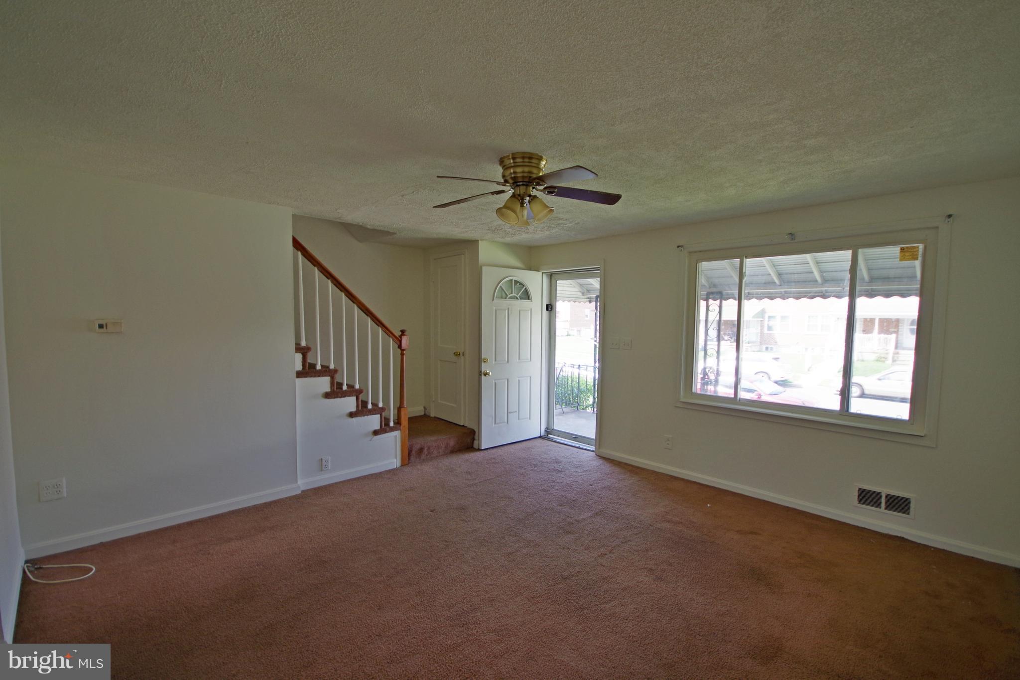 7457 Lawrence Road Dundalk, MD 21222 - Photo 5 of 24 a view of an empty room with a window