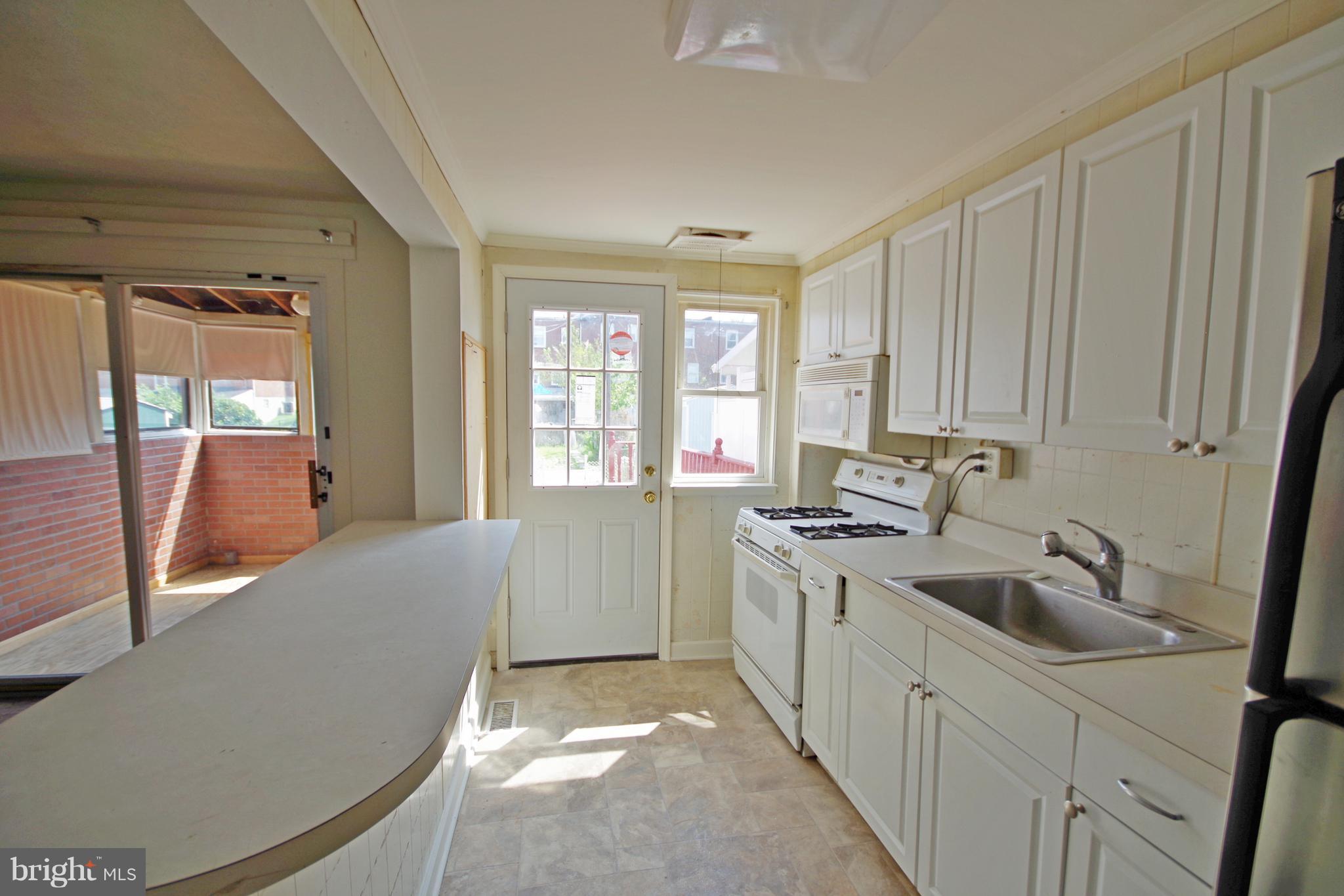 7457 Lawrence Road Dundalk, MD 21222 - Photo 9 of 24 a kitchen with a sink and cabinets