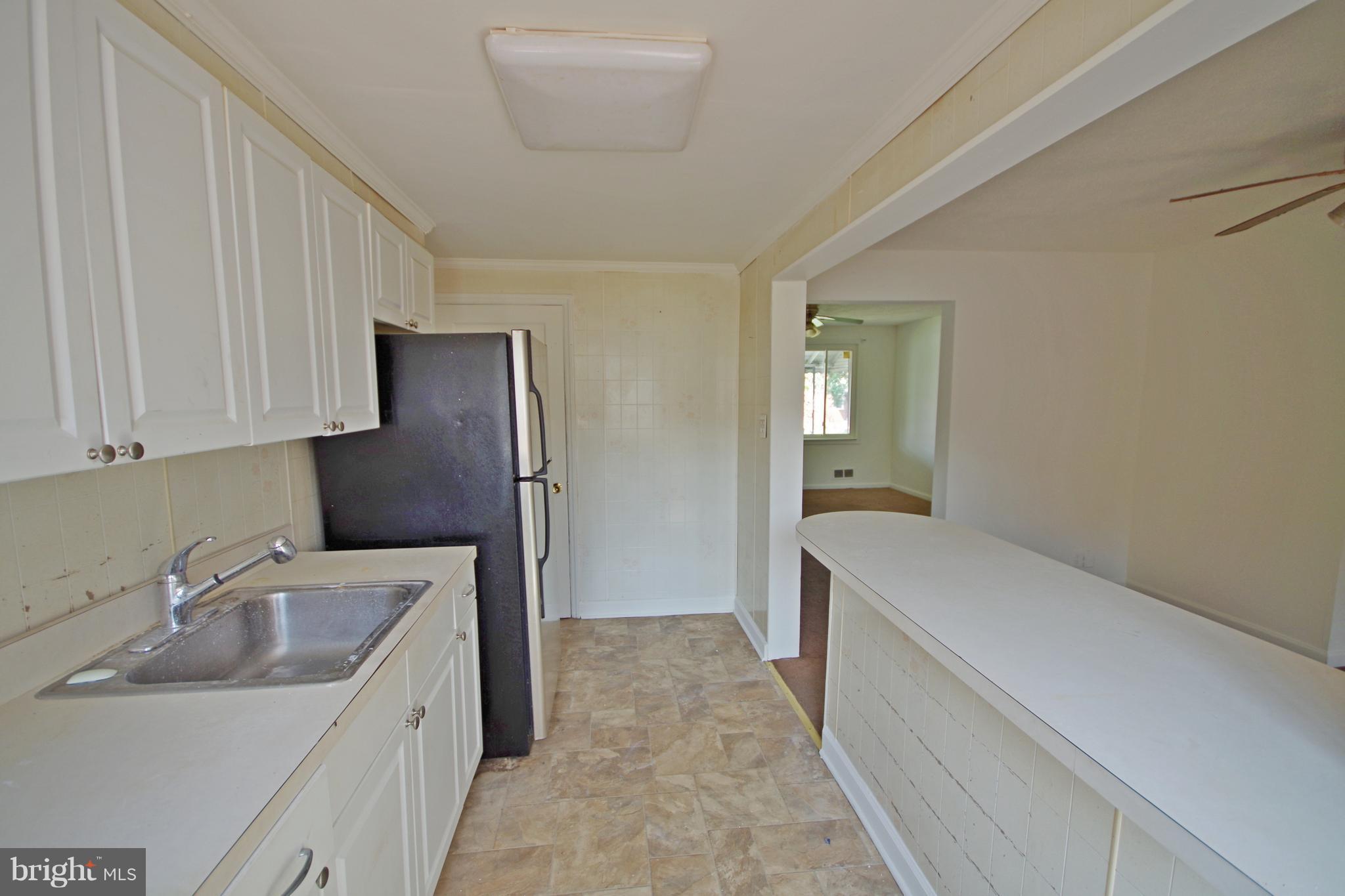 7457 Lawrence Road Dundalk, MD 21222 - Photo 10 of 24 a kitchen with a sink and cabinets