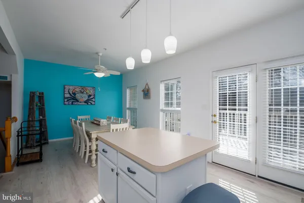 a kitchen with a stove a sink a dining table and chairs