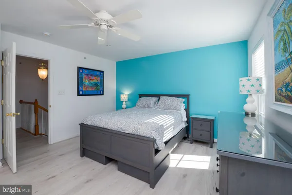 a bedroom with a bed dresser and a window