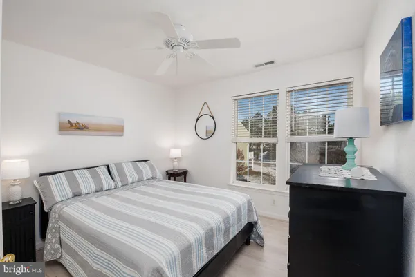 a bedroom with a large bed and a desk