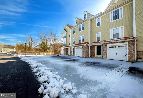 a view of a house with a snow in the yard