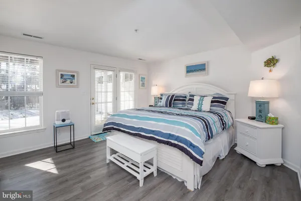 a spacious bedroom with a bed and window