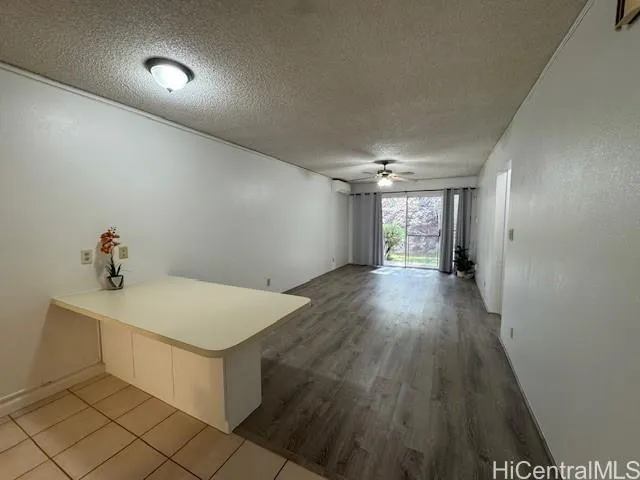 a view of an empty room and wooden floor