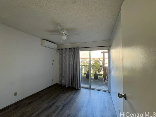 an empty room with wooden floor and a window