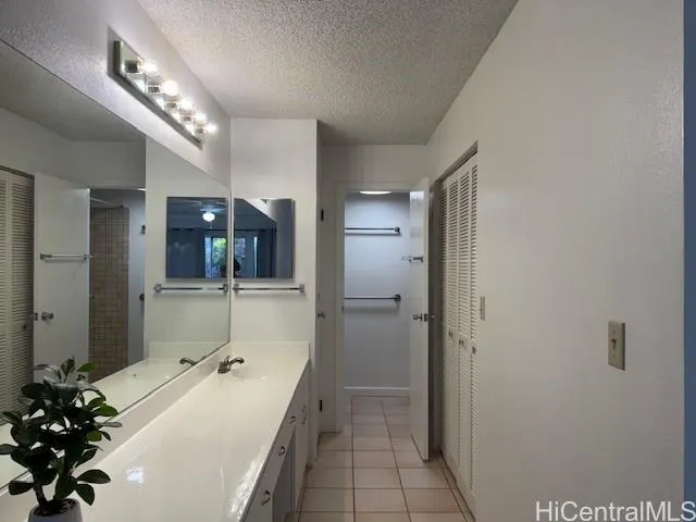 a spacious bathroom with a double vanity sink and mirror