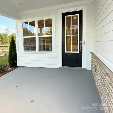 a front view of a house with a large window