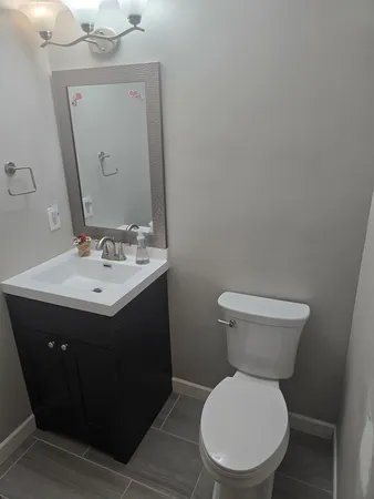 a bathroom with a sink toilet and mirror