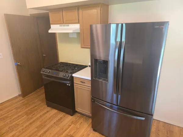 a kitchen with metallic refrigerator freezer and a dishwasher