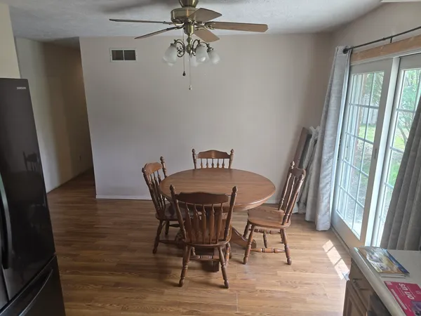 a view of a dining room with furniture window and wooden floor