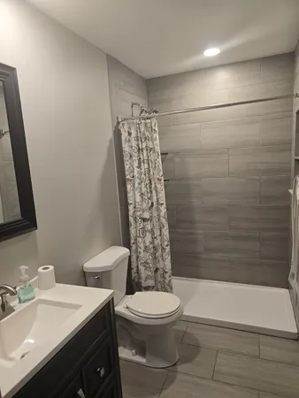 a bathroom with a toilet a sink and bathtub