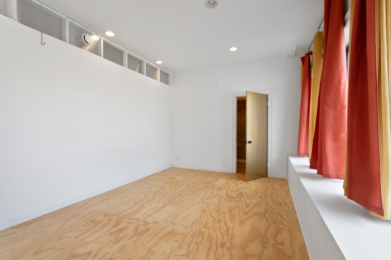 4837 West Irving Park Road, Unit 2 Chicago, IL 60641 - Photo 18 of 24 a view of a big room with wooden floor and windows