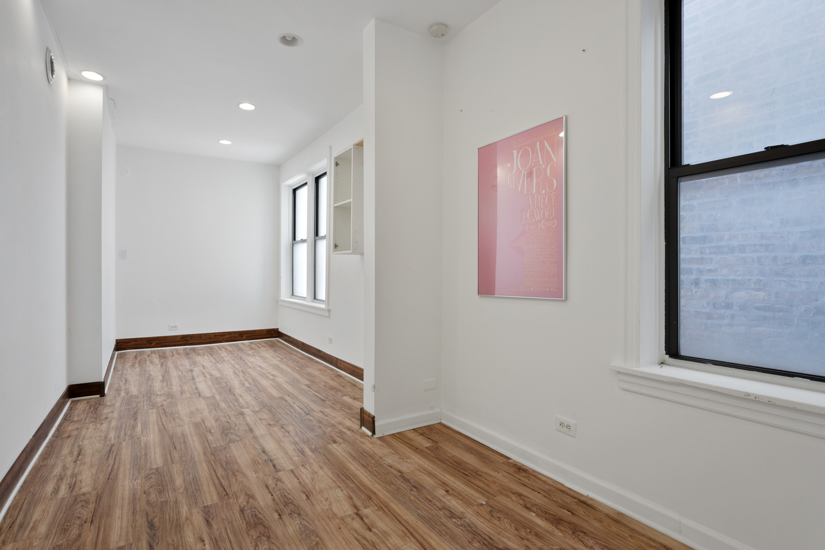4837 West Irving Park Road, Unit 2 Chicago, IL 60641 - Photo 20 of 24 a view of an empty room with wooden floor and a window