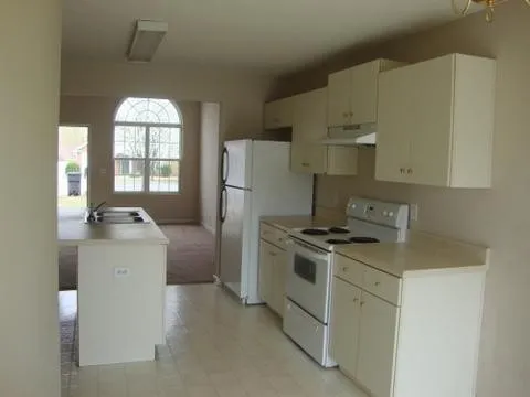 a kitchen with a stove and a refrigerator