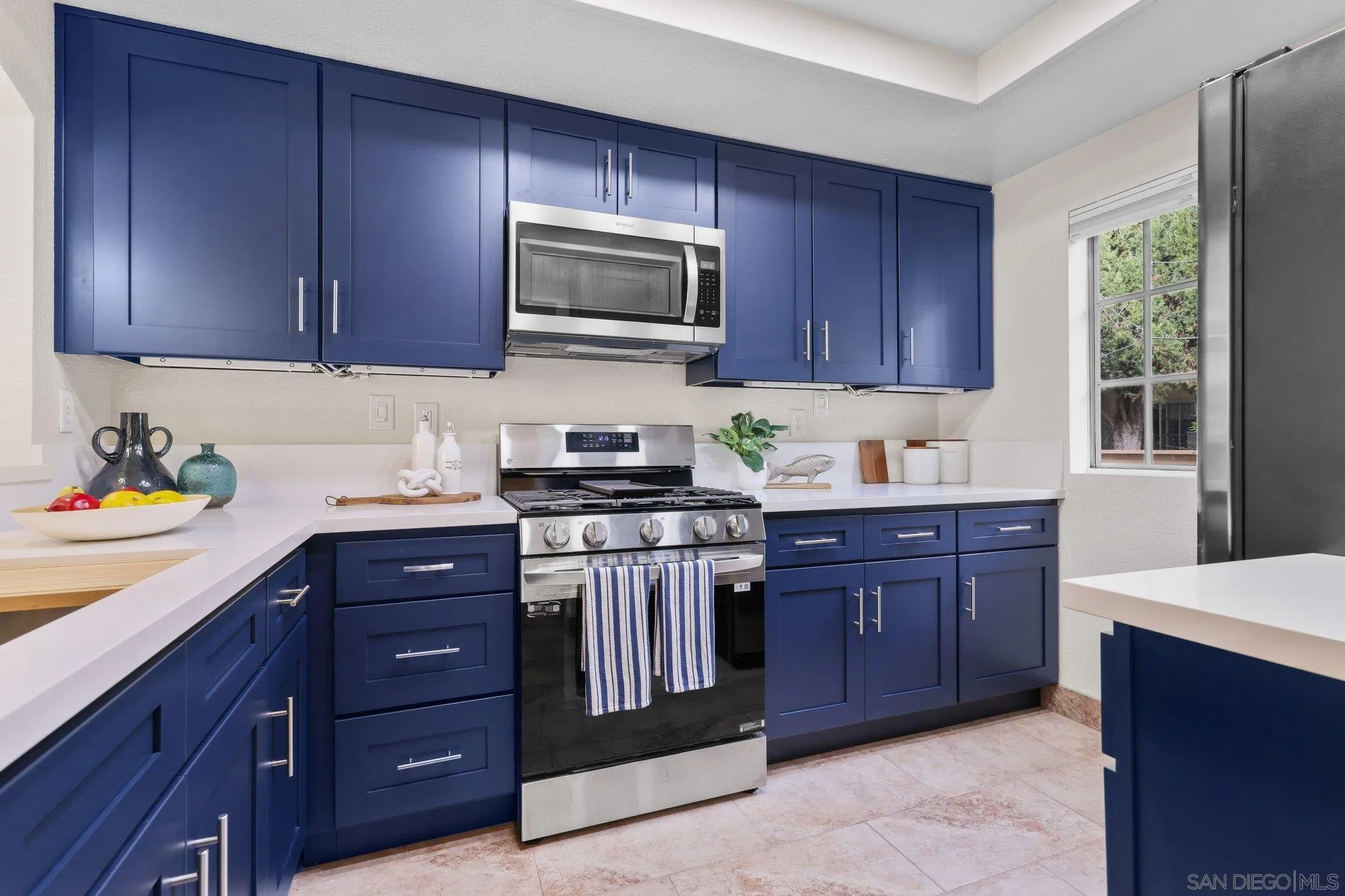 a kitchen with granite countertop wooden cabinets and stainless steel appliances