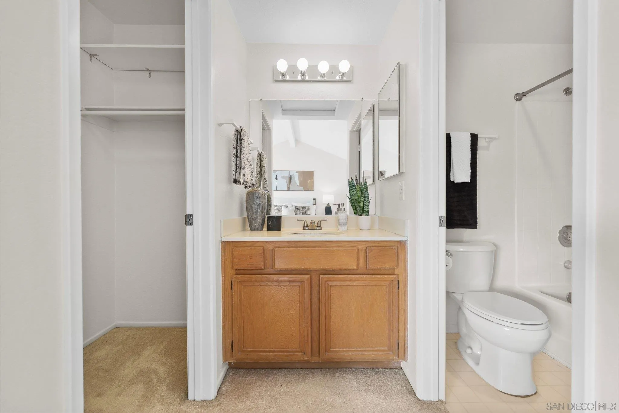 740 Breeze Hill Road, Unit 193 Vista, CA 92081 - Photo 21 of 35 a bathroom with a toilet sink and mirror