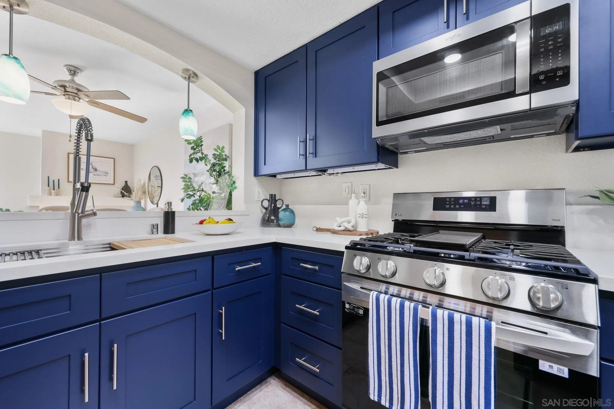 740 Breeze Hill Road, Unit 193 Vista, CA 92081 - Photo 3 of 35 a kitchen with stainless steel appliances granite countertop wooden cabinets and a stove top oven