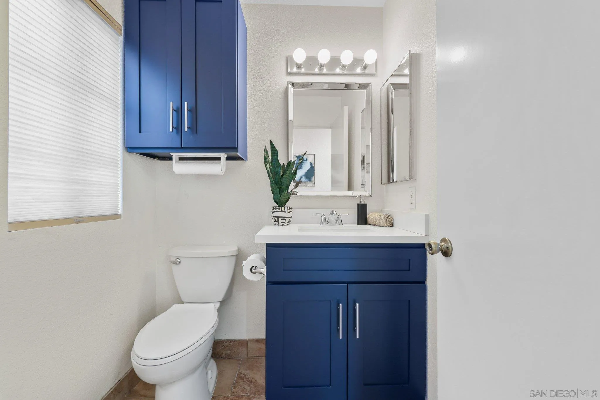 740 Breeze Hill Road, Unit 193 Vista, CA 92081 - Photo 5 of 35 a bathroom with a toilet a sink and mirror