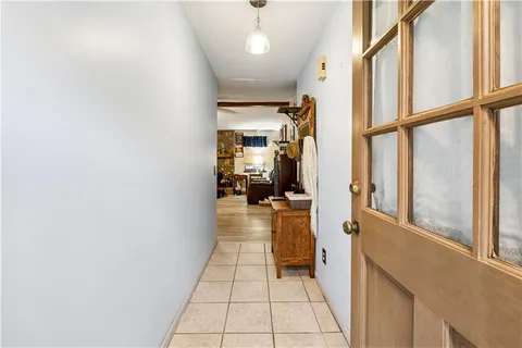 a view of a hallway with furniture and a window