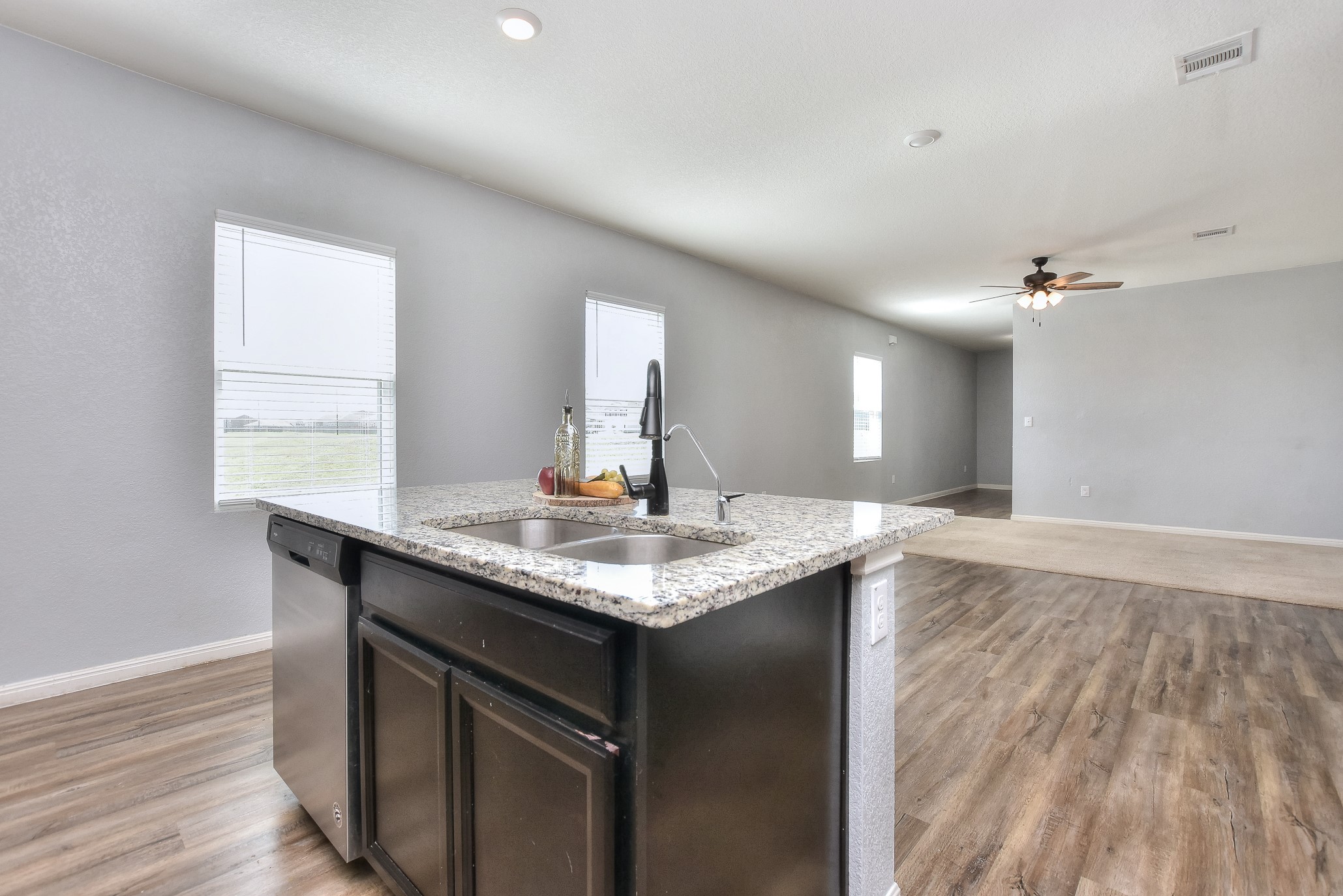 109 Helios Drive Jarrell, TX 76537 - Photo 12 of 32 a kitchen with granite countertop a sink and wooden floor