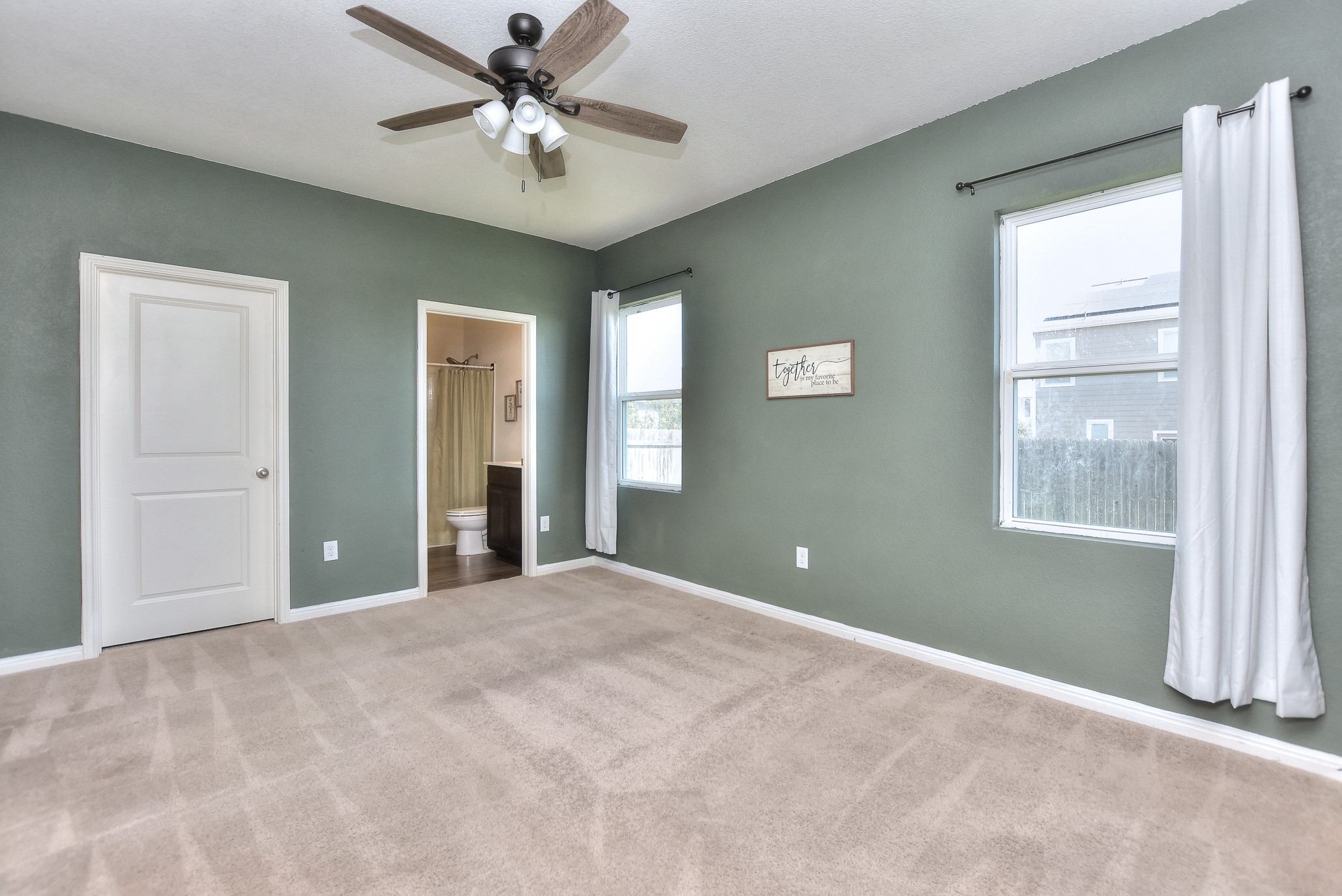 109 Helios Drive Jarrell, TX 76537 - Photo 15 of 32 a view of a big room with windows and chandelier fan
