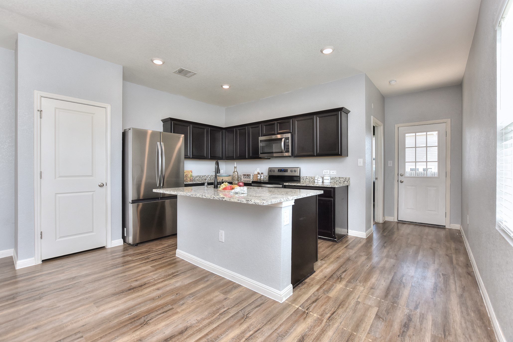 109 Helios Drive Jarrell, TX 76537 - Photo 7 of 29 a kitchen with stainless steel appliances granite countertop a refrigerator stove and oven