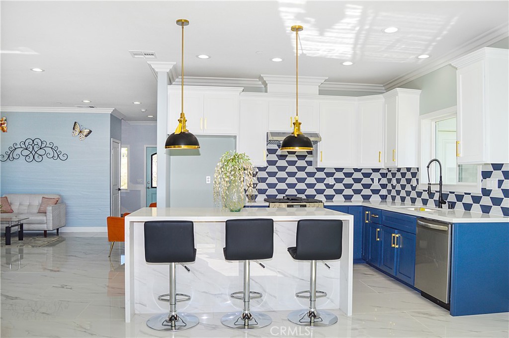 29329 Kemper Lane Highland, CA 92346 - Photo 22 of 75 a kitchen with stainless steel appliances kitchen island granite countertop a table and chairs