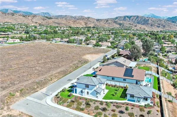 an aerial view of house with a yard and balcony