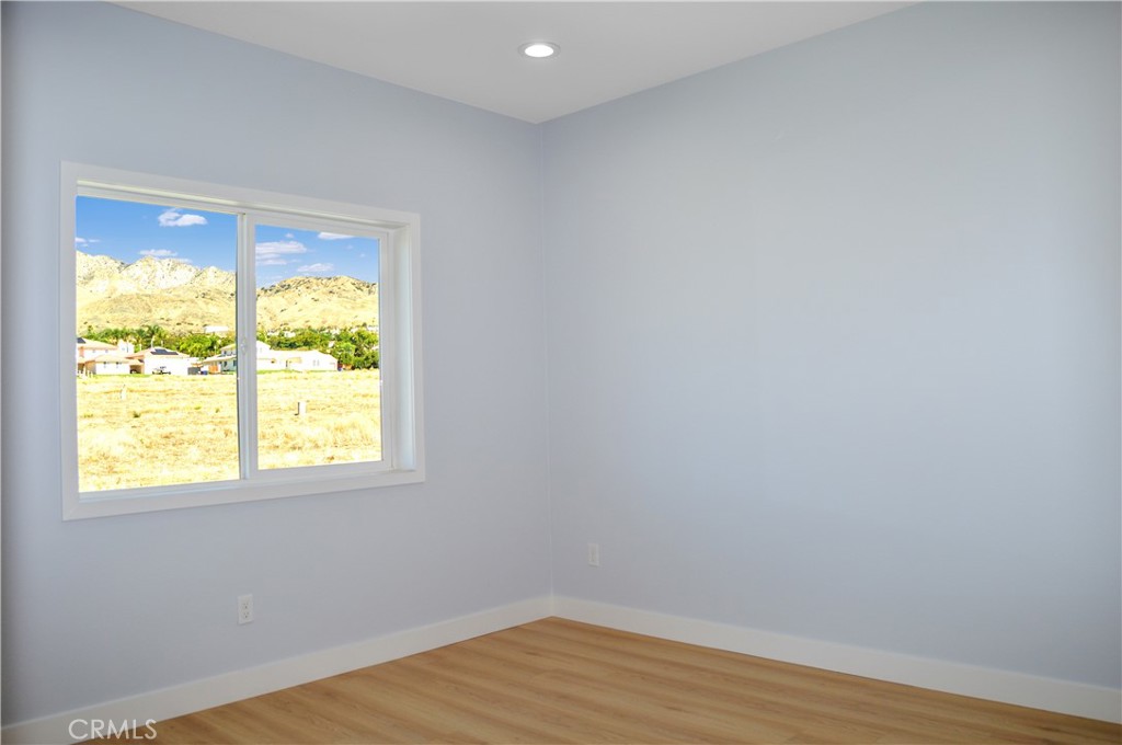 29329 Kemper Lane Highland, CA 92346 - Photo 44 of 75 a view of an empty room with wooden floor and a window