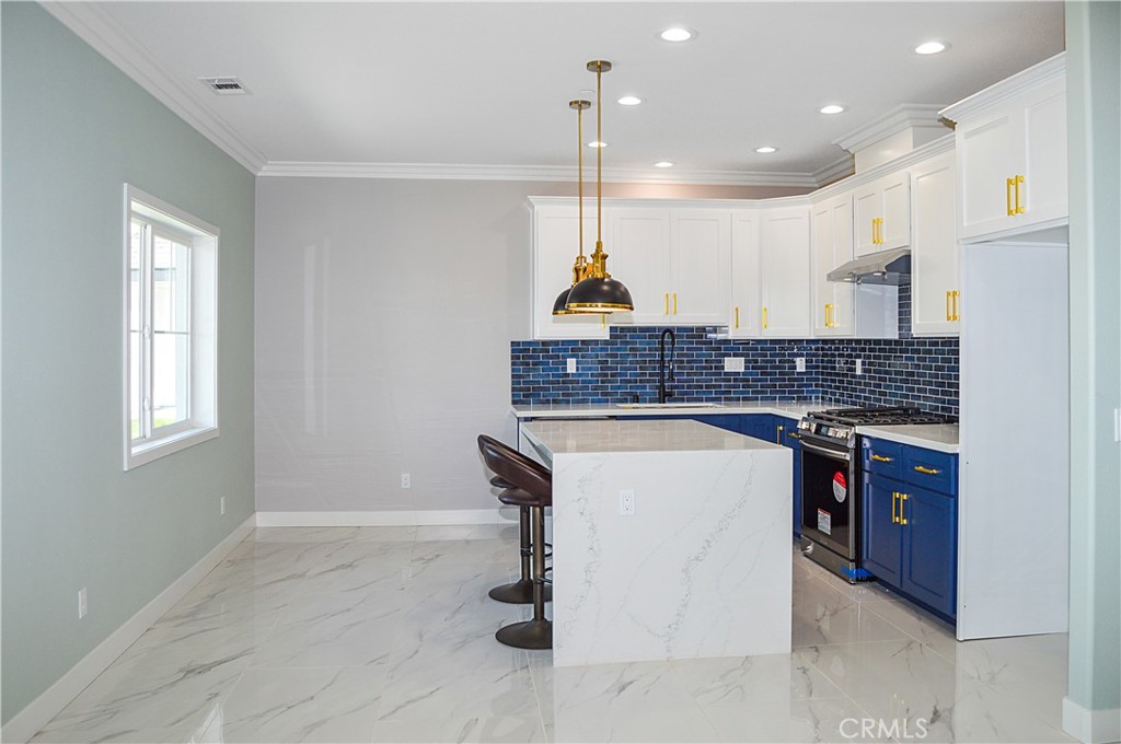 29329 Kemper Lane Highland, CA 92346 - Photo 59 of 75 a kitchen with stainless steel appliances granite countertop a sink a stove a refrigerator and a window