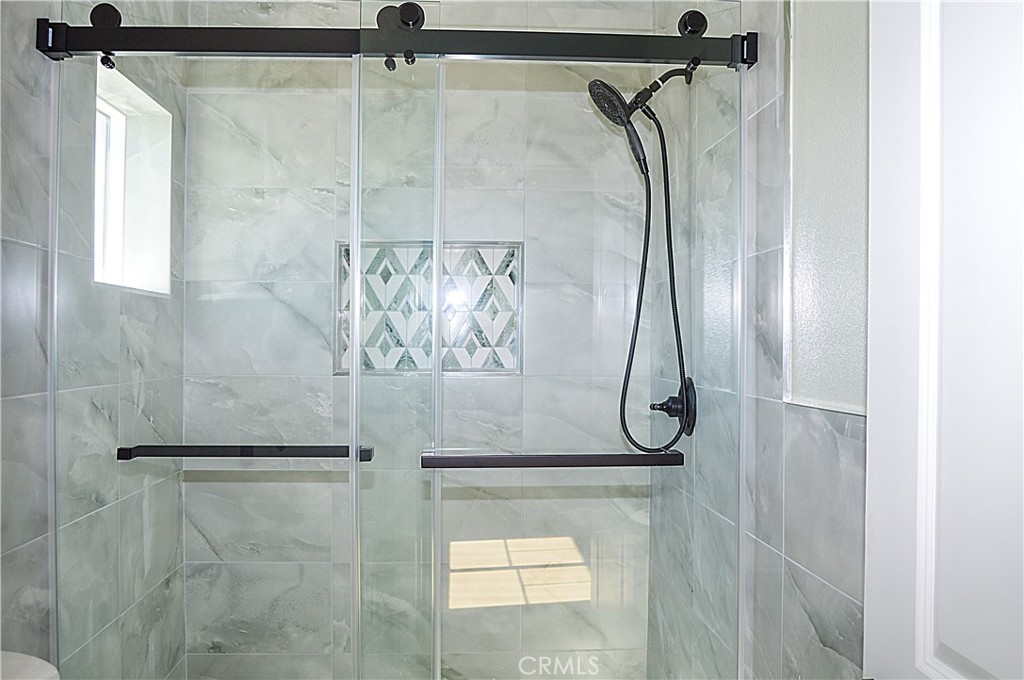 29329 Kemper Lane Highland, CA 92346 - Photo 66 of 75 a bathroom with a glass shower door