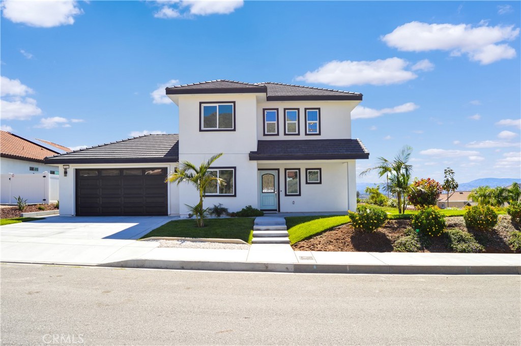 29329 Kemper Lane Highland, CA 92346 - Photo 6 of 75 a front view of a house with a yard and garage