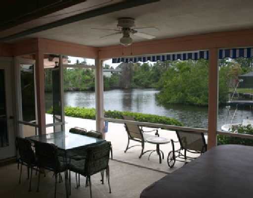 706 Irwin Lane Jupiter, FL 33458 - Photo 11 of 16 a patio with yard glass top table and chairs