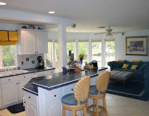 706 Irwin Lane Jupiter, FL 33458 - Photo 13 of 16 a large kitchen with a table chairs sink and cabinets