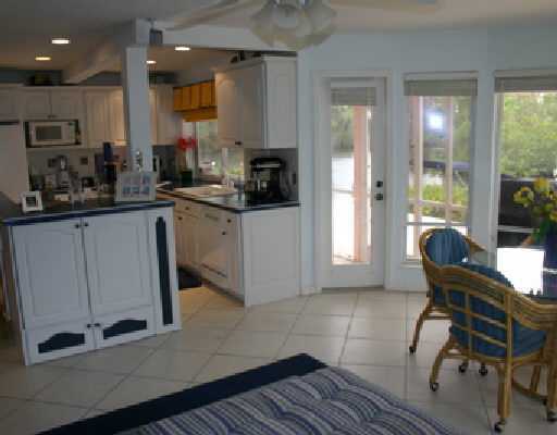 706 Irwin Lane Jupiter, FL 33458 - Photo 14 of 16 a kitchen with a sink cabinets and dining table chair