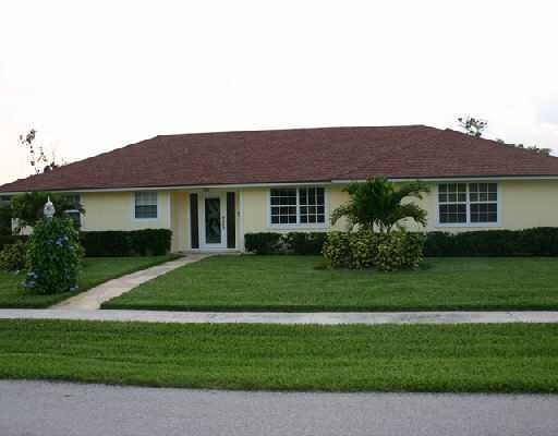 706 Irwin Lane Jupiter, FL 33458 - Photo 2 of 16 a front view of a house with a garden