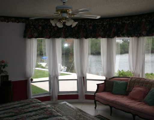 706 Irwin Lane Jupiter, FL 33458 - Photo 7 of 16 a living room with furniture and a floor to ceiling window