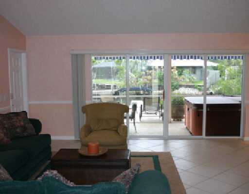 706 Irwin Lane Jupiter, FL 33458 - Photo 9 of 16 a living room with furniture and a large window