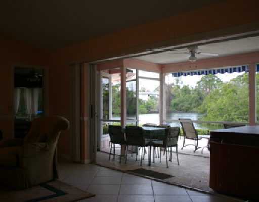 706 Irwin Lane Jupiter, FL 33458 - Photo 10 of 16 a view of a porch with furniture and garden