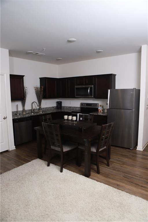 11900 Fuller Street Hampton, GA 30228 - Photo 6 of 17 a kitchen with stainless steel appliances a refrigerator and a stove top oven
