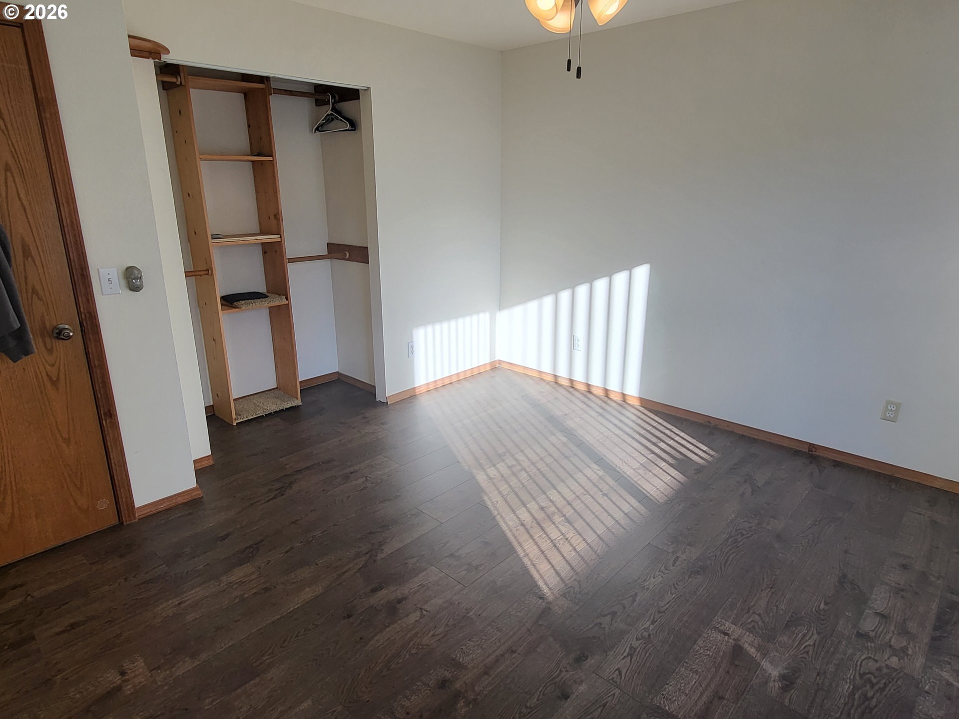963 Crocker Street Coos Bay, OR 97420 - Photo 18 of 42 an empty room with wooden floor and staircase