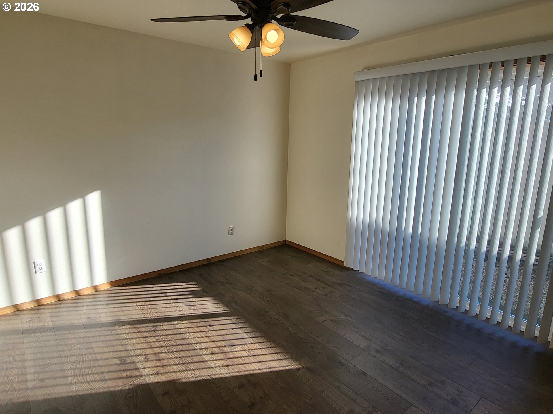 963 Crocker Street Coos Bay, OR 97420 - Photo 19 of 42 a view of an empty room with wooden floor and a window
