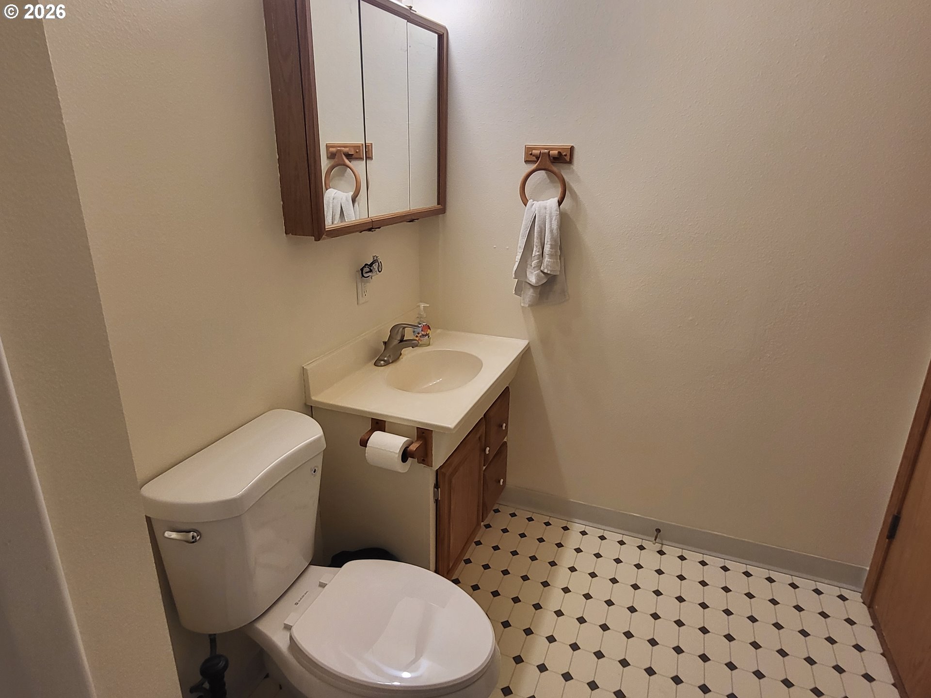 963 Crocker Street Coos Bay, OR 97420 - Photo 27 of 42 a white toilet sitting next to a bathroom sink